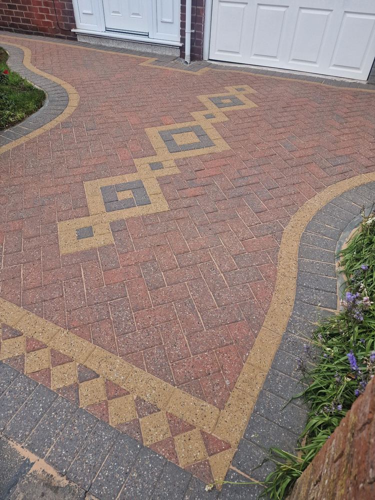 A patterned block paving driveway just after re-sanding: kiln-dried sand brushed into every joint